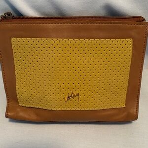 Leather  tan and mustard tone clutch .